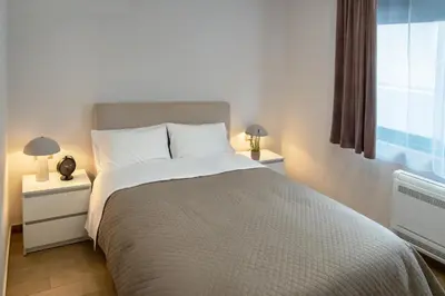 a bedroom with a large bed and two night stands at Stelina Apartment in Chania Town