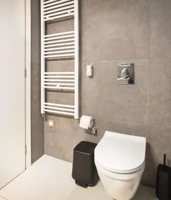 a bathroom with a white toilet and a window at Stelina Apartment in Chania Town