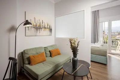 a living room with a couch and a table at Zen City Apartment in Chania Town