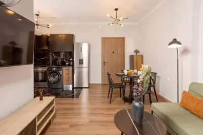 a living room with a kitchen and a dining room at Zen City Apartment in Chania Town