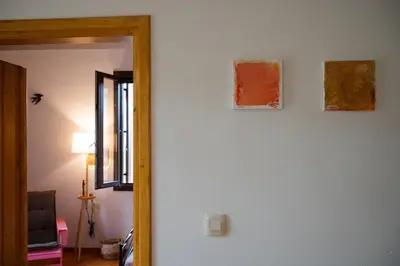 a room with two paintings on the wall and a mirror at Telesilla's home in Apothíkai