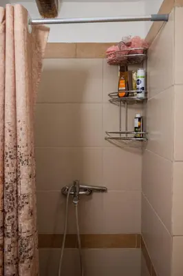 a bathroom with a shower with a shower curtain at Telesilla's home in Apothíkai