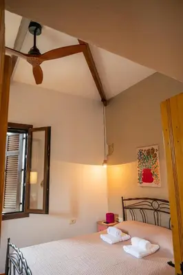 a bedroom with a bed with two towels on it at Telesilla's home in Apothíkai