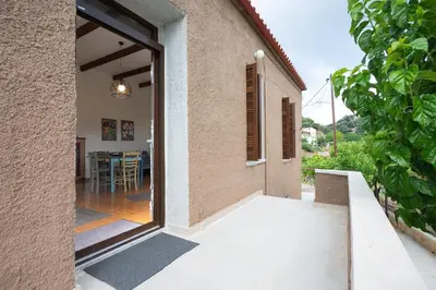 an open door to a house with a dining room at Telesilla's home in Apothíkai