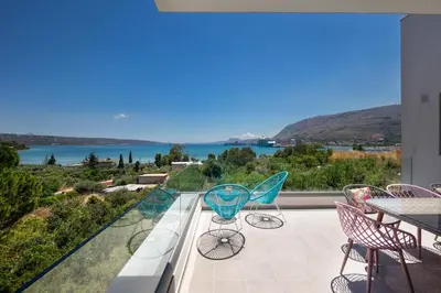 a balcony with a view of the water at Villa Narciso in Souda