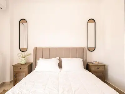 a bedroom with a large bed with two night stands at Chania sea view apartment - Crete in Galatás