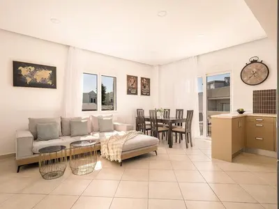 a living room with a couch and a table at Chania sea view apartment - Crete in Galatás