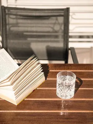 a book and a glass sitting on a table with a table at Chania sea view apartment - Crete in Galatás