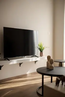 a living room with a flat screen tv on a wall at Theni City Apartment by Zen Estate in Chania Town