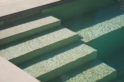 a set of stairs with reflections in the water at Mythelea Luxury Villa in Kissamos