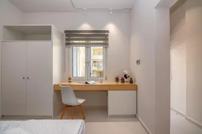 a bedroom with a desk with a chair and a window at Dreams 4 you in Chania Town