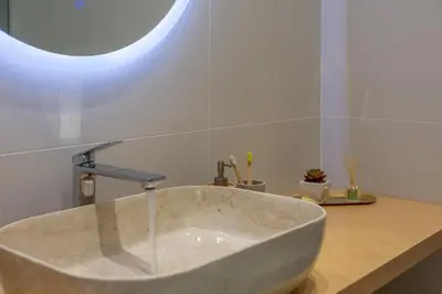 a bathroom with a large marble sink with a window at Dreams 4 you in Chania Town