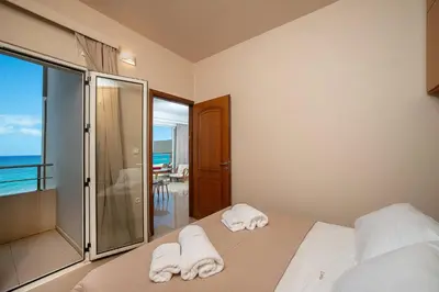 a bedroom with a bed with towels on it at Cielo Vista in Stalos