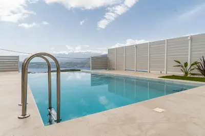 a swimming pool with a view of the mountains at Fantasea Villas, villa Lumi in Stérnai