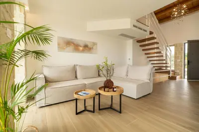 a living room with a couch and a table at Fantasea Villas, villa Lumi in Stérnai