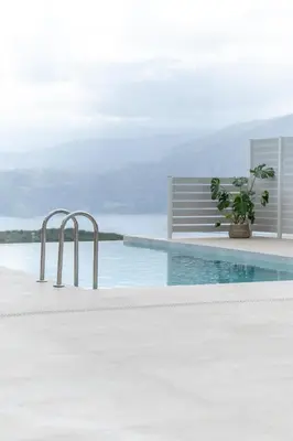 a swimming pool with a potted plant sitting on the edge of it at Fantasea Villas, villa Lumi in Stérnai