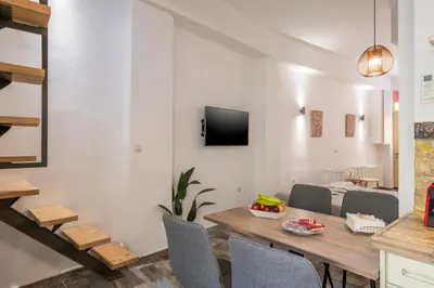 a dining room with a table and chairs at Crescendo Splantzia in Chania Town