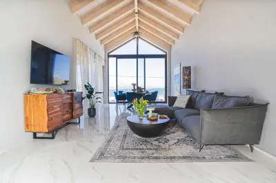 a living room with a couch and a table at Villa Orama - Sea view with private pool in Kalyves
