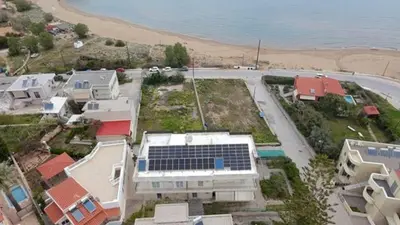 an aerial view of a house with a solar array at Beachfront apartment in Daratso