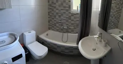 a bathroom with a sink and a toilet and a bath tub at Melina's house in Skinés