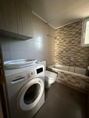a bathroom with a washing machine and a toilet at Melina's house in Skinés