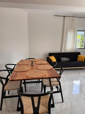 a table and chairs in a living room with a couch at Melina's house in Skinés