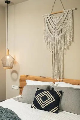a bedroom with a bed and a hanging decoration at Raviewha Luxury Apartments 2 in Ravdhoúkha
