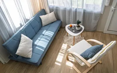 a living room with a blue couch and a table at View West Elafonisi house in Livadia