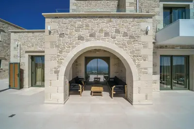an archway in a building with a patio at Nafsika Xenia - Odysseus in Falasarna