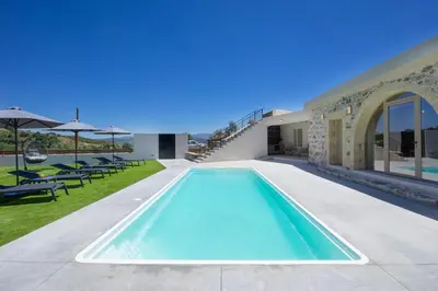 a swimming pool in the backyard of a villa at Villa George in Límni