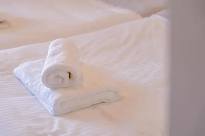 a stack of white towels sitting on a bed at Villa Avelios in Karefilianá