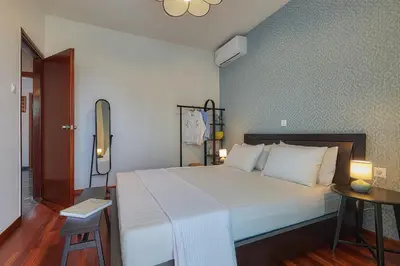 a bedroom with a large bed with white pillows at Katsambas Apartment - Cozy Retro-Luxury with Balcony in Chania Town