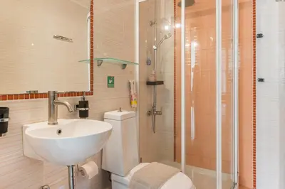 a bathroom with a sink and a toilet and a shower at Casa Barbara in Stalos