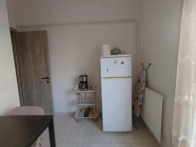 a small kitchen with a white refrigerator in a room at Lumen Chania in Chania Town