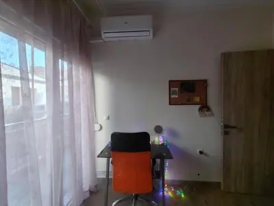 a room with a desk and a chair and a window at Lumen Chania in Chania Town