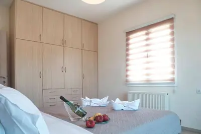 a bedroom with a bed with a bowl of fruit on it at Tzei House - 5min drive to beach in Perivólia