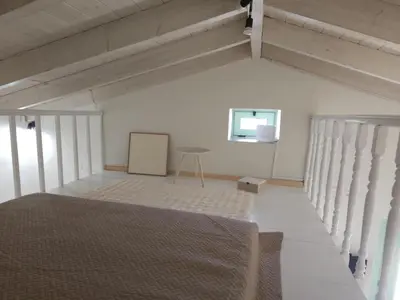 a white room with a bed and a table at Elaida Home in Psathoyiánnos