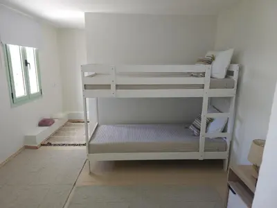 a room with two bunk beds in a room at Elaida Home in Psathoyiánnos