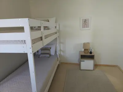 a bedroom with two bunk beds and a table at Elaida Home in Psathoyiánnos