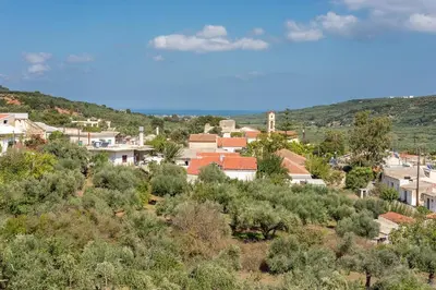 a town on a hill with trees and buildings at Lilly Traditional Cretan Villa in Dhrakóna