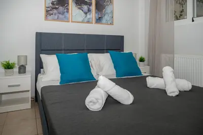 a bedroom with a bed with towels on it at Be Crete - Horizon in Chania Town