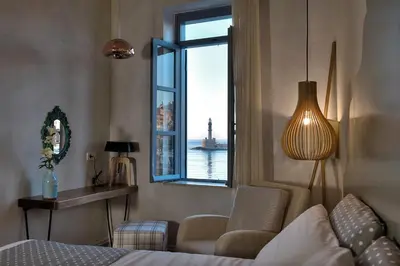 a room with a bed and a window with a view at Elia Zampeliou Hotel in Chania Town