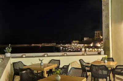 a view of the city from a restaurant with tables and chairs at Elia Zampeliou Hotel in Chania Town
