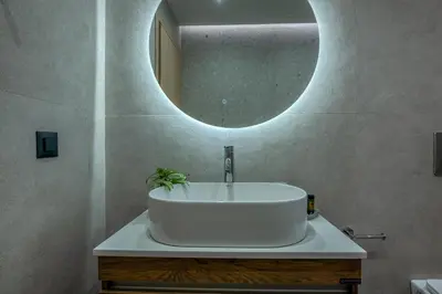 a bathroom with a white sink and a mirror at Gems - Stunning 2BR Apts - Steps from the Beach! in Kissamos