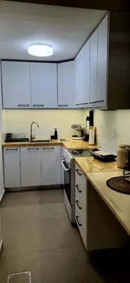 a kitchen with white cabinets and a sink at Mposkini house - next to Chania town center in Chania Town
