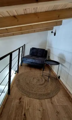 a room with a bed and a table and a rug at Mposkini house - next to Chania town center in Chania Town
