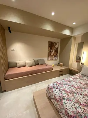 a bedroom with a large bed with avertisementatronatronatronstrationstrationstrationstration at Saxon's Corner in Chania Town