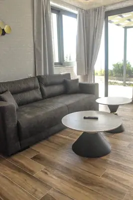 a living room with a couch and a table at Luxury apartment Reverie in Sfakiá