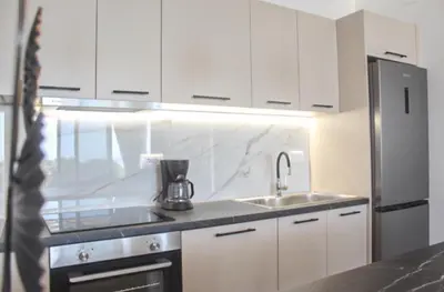 a kitchen with a sink and a refrigerator at Luxury apartment Reverie in Sfakiá