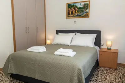 a bedroom with a bed with two towels on it at Lumea Apartment in Chania Town